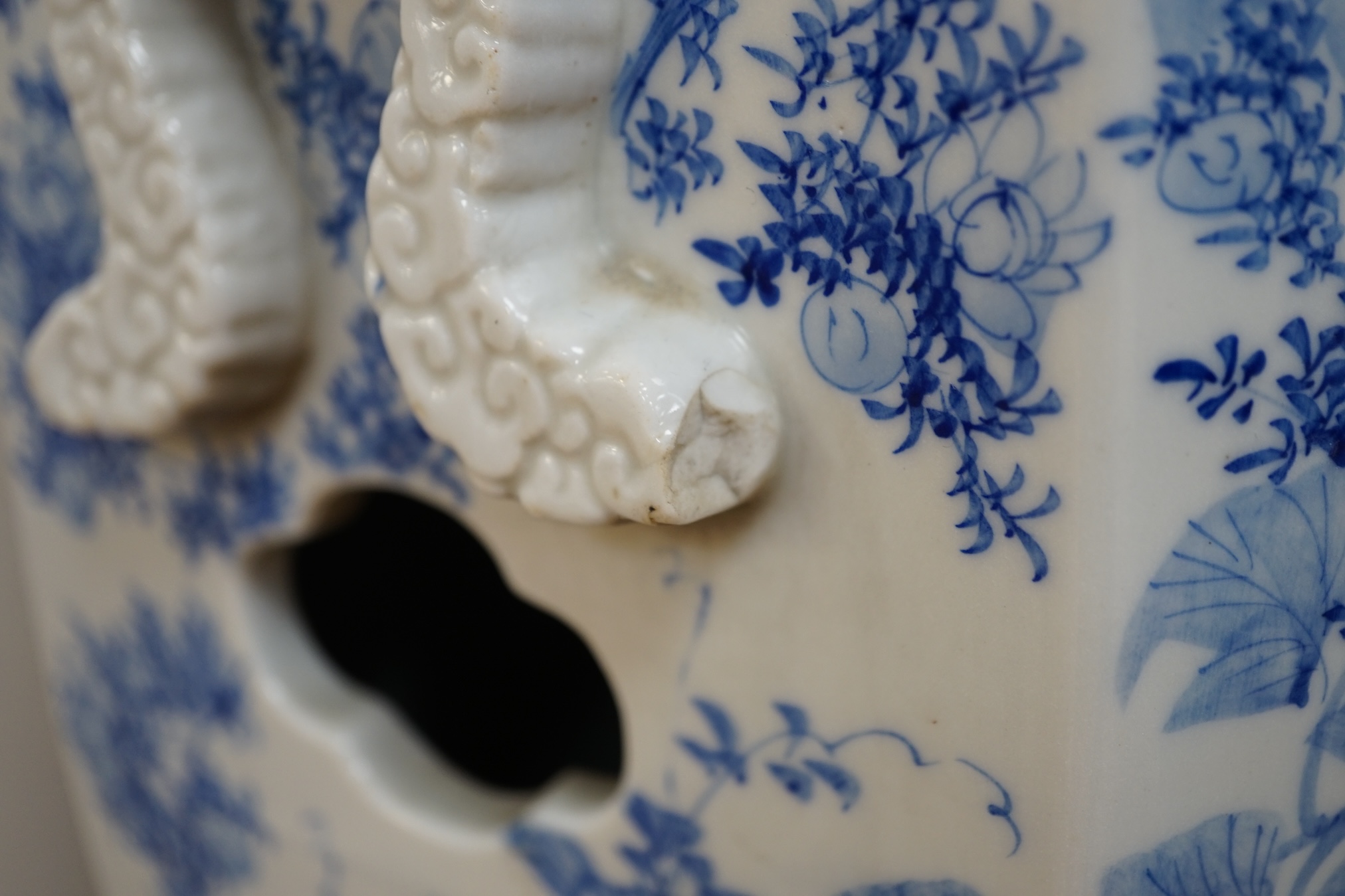 An early 20th century Japanese hexagonal blue and white porcelain garden seat, 50cm high. Condition- fair, has hairline crack